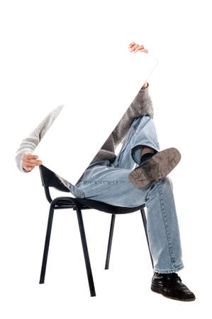 man in a chair with a magazine on a white backgroundの写真素材