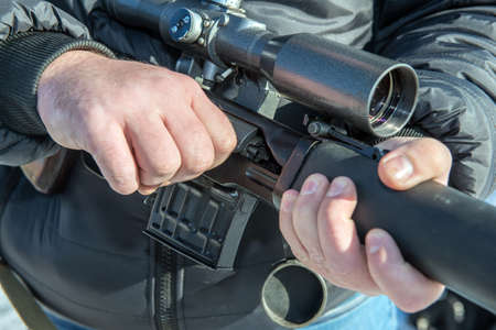 insurgent sniper with SVD rifle the aiming in forestの写真素材