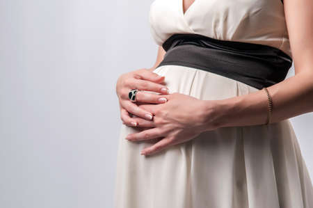 view of a pregnant woman on a gray backgroundの写真素材