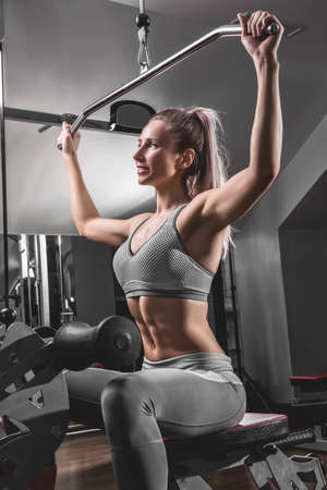 Portrait of sporty female doing physical exercise in gym
