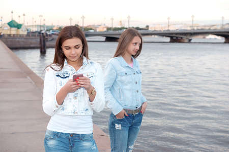 Two young beautiful girls are walking through the cityの写真素材