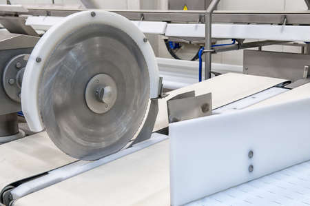 Industrial production cutting large quantities of meatのeditorial素材