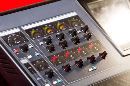 Sound technician and lights technicians control the music show in night club.Professional audio,...