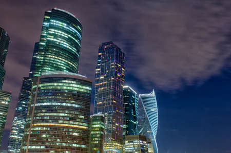 Moscow city skyscrapers and reflection in the Moscow river against the blue sky on a summer night