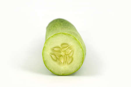 A fresh and tasty green vine ripened garden grown cucumber isolated on white の写真素材