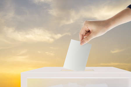 Hand holding ballot paper for election vote at place election background. Election vote concept.