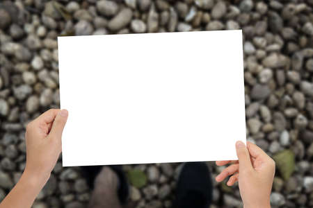 Hands holding paper at top view walkway background.