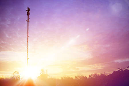 Telecommunication tower antenna at sunset sky.の写真素材