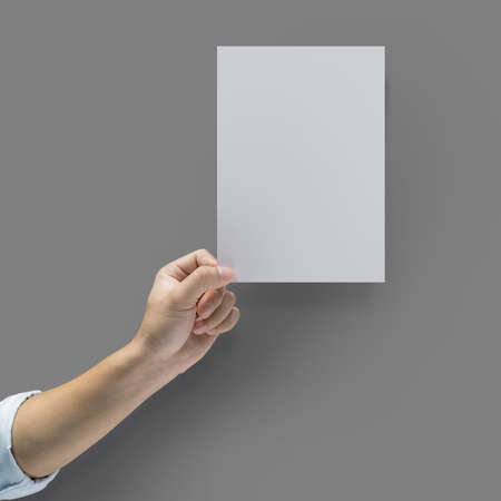 Hand holding a blank brochure booklet mock up.
