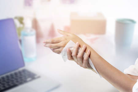 Woman cleaning her hand wet wipe, Healthcare and medical concept.