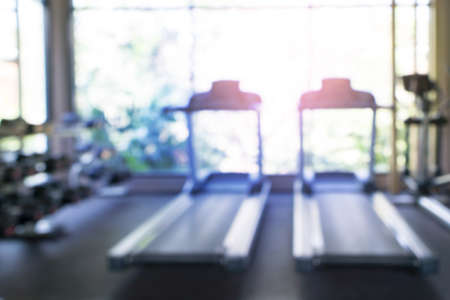 Abstract blurred gym equipment and fitness room interior for background