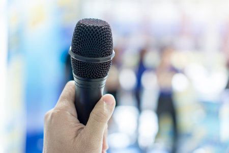 Close up of hand holding microphoneの写真素材