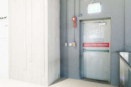 Exit sign and fire extinguisher at building.の写真素材