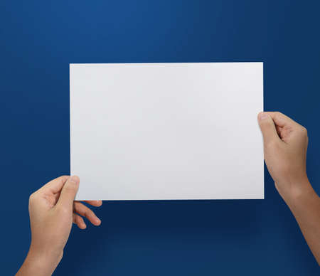 Hands holding paper blank a4 size for letter paper.