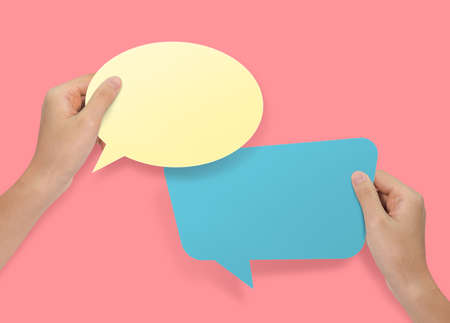 Hand holding an empty speech bubble at background.の写真素材
