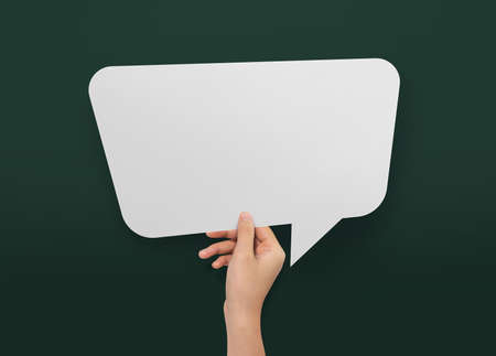 Hand holding an empty speech bubble at background.の写真素材