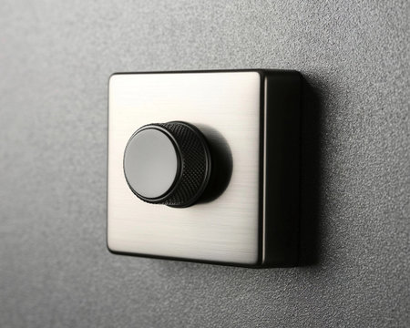 Close up of a power button on a wall in a room.の素材