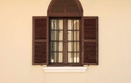 vintage window on light brown wall の写真素材