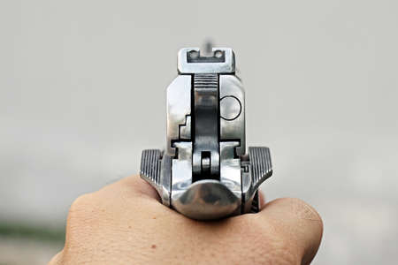 Human hand holding gun, hand aiming a handgun, 45 pistolの写真素材