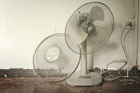 Dirty on old electric fan,Old electric fan, Cooling fan, Electric fan in hot weather  Process in warm tone color の写真素材