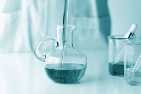 Beauty cosmetics sciences, Formulating and mixing skincare with herbal essence, Scientist pouring...