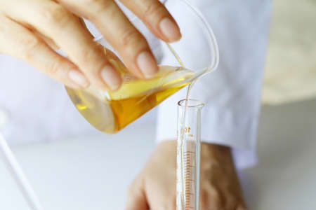 Beauty cosmetics sciences, Formulating and mixing skincare with herbal essence, Scientist pouring organic essential oil, Alternative healthy medicine.の写真素材
