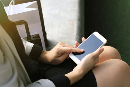 Close up of a woman using mobile smart phone outdoor, Office lady working out.の写真素材