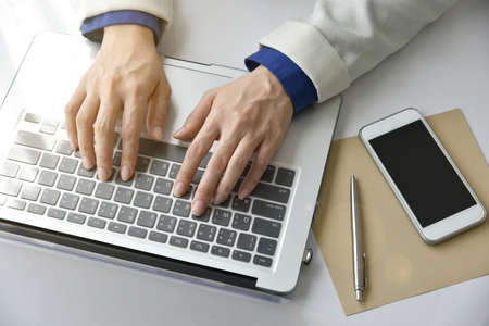 Working woman in the office, Woman sitting at desk and working at laptop computer.の写真素材