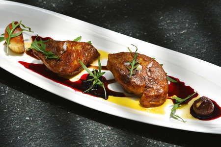 Foie gras grilled served with red berries sauce and chestnut.の写真素材