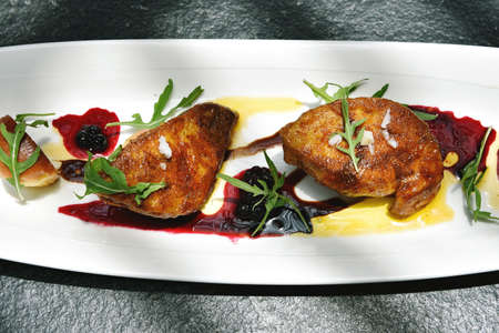 Foie gras grilled served with red berries sauce and chestnut.の写真素材