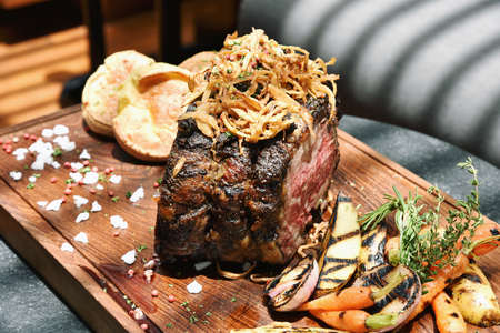 Lamb leg grilled, Roasted lamb leg served with grilled organic vegetable and pepper sauce.の写真素材