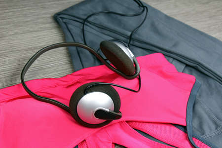 Headphones and smartphone to listen to music while working out at the fitness center. Matching...
