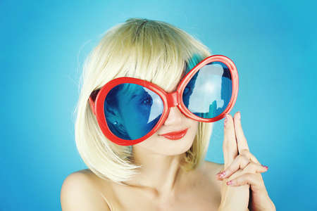 Girl Party, Young woman making a gun from fingers, Blonde woman making gun gesture, Funny glasses, Finger Gun.の写真素材