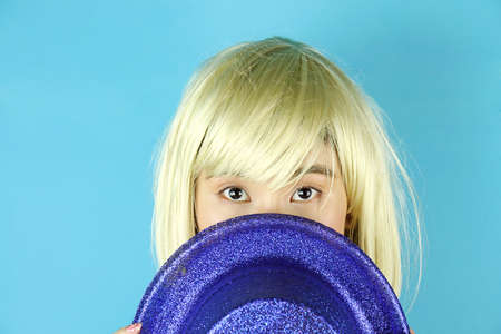 Girl Party, Blond woman wearing blue glitter party hat, Glamorous lady in disco style New Year's party.の写真素材