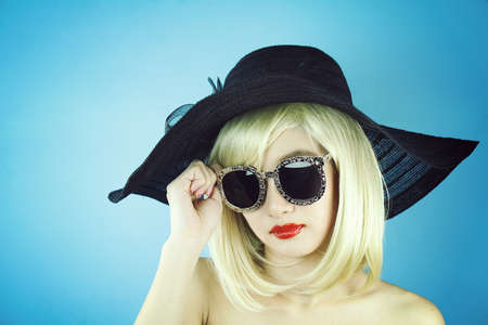 Summer girl, Glamor stylish beautiful young woman model with red lips and hipster sunglasses, Young sexy girl in brown summer hat, High Fashion look.の写真素材