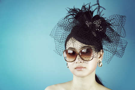 Retro Woman Portrait. Vintage Style Girl Wearing Old fashioned Hat, Beautiful black hat with feathers. Romantic Beauty.の写真素材