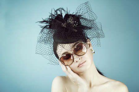 Retro Woman Portrait. Vintage Style Girl Wearing Old fashioned Hat, Beautiful black hat with feathers. Romantic Beauty.の写真素材
