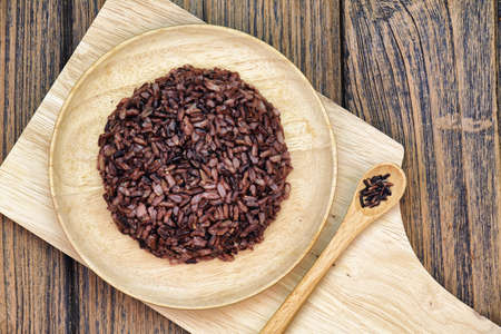 Cooked rice berry (purple rice) on wooden plate, Ready to eat, Eat clean concept. (Color Processed)の写真素材