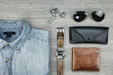 Men accessories and fashion, Set of clothes and various accessories, Trendy Hipster style outfits, Jeans Shirt, Watch, Wallet, Sunglasses, Necklace, Ring. (Color Process)の写真素材