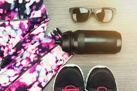 Women's sport wear, Gym fashion and accessories, Exercise Equipment, Healthy lifestyle concept, Shoes, Sunglasses, Bottle. (Lighting Effect Processed)の写真素材