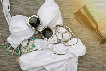 Fashion swimsuit bikini and vintage accessories, Summer clothes, swimwear, sunglasses and necklace. Stylish luxury accessories.の写真素材