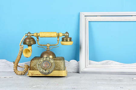Luxury Vintage telephone and white frame over retro background.の写真素材