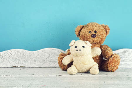 Stuffed animal toys on the white wooden table, Animal dolls, Friendship concept. (Vintage Style Color)の写真素材