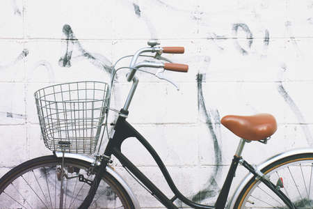 Vintage bicycle. Beautiful vintage bicycle standing near the wall. (Soft Light And Color Process)の写真素材