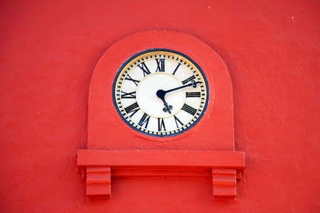 Vintage clock on an old stucco wall. Tower clock.