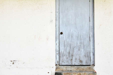 Old house wall with Wooden blue door.の写真素材