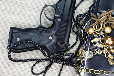 Woman bag with gun hidden, Handgun and accessories falling from a woman's purse.
