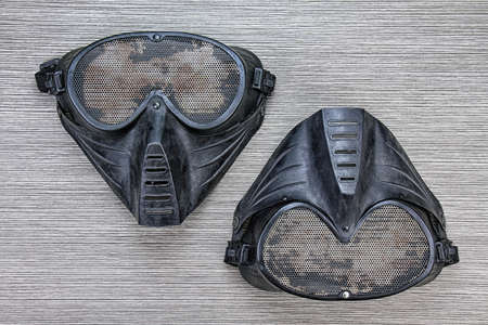 Airsoft BB gun metal mesh mask, Face safety protection from shooting sport game, Terrorist look mask on wood background.. (Grunge Effect Process)の写真素材