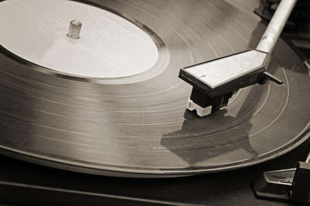 Record player stylus on a rotating disc, Picture of a vinyl record playing.の写真素材