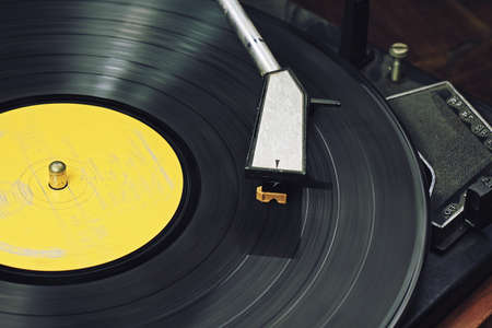 Record player stylus on a rotating disc, Picture of a vinyl record playing.